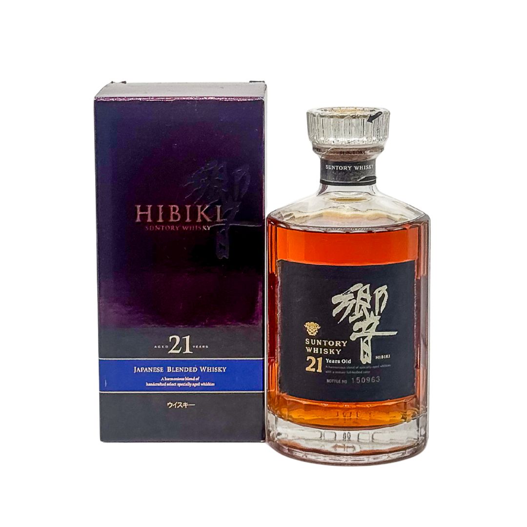 Hibiki 21 Year Old 1990s Flower Crest Gold Cap Japanese Blended Whisky (Bottle no: 150963) is a highly prized and collectible expression from Suntory’s iconic Hibiki range. Released in the 1990s, it features the distinctive gold cap and a flower crest on the label, symbolizing its era and rarity.